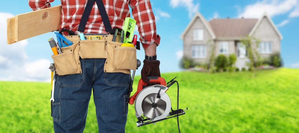 A man holding a tool belt and a tool bag